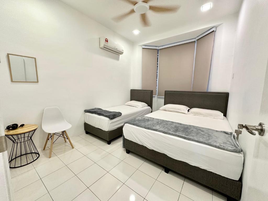 a bedroom with two beds and a ceiling fan at Sakura 1 Homestay Kampar Landed in Kampar