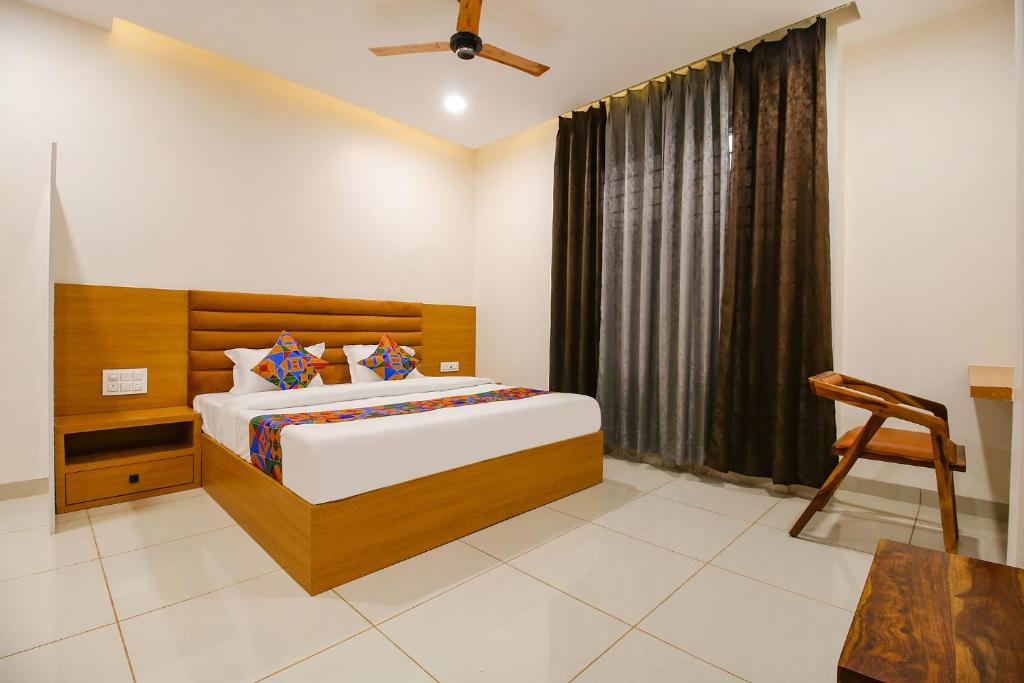 a bedroom with a bed and a window at FabHotel The Gravity Inn in Indore