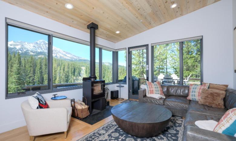 a living room with a couch and a table at Lake Cabin 19 Lakewood in Big Sky