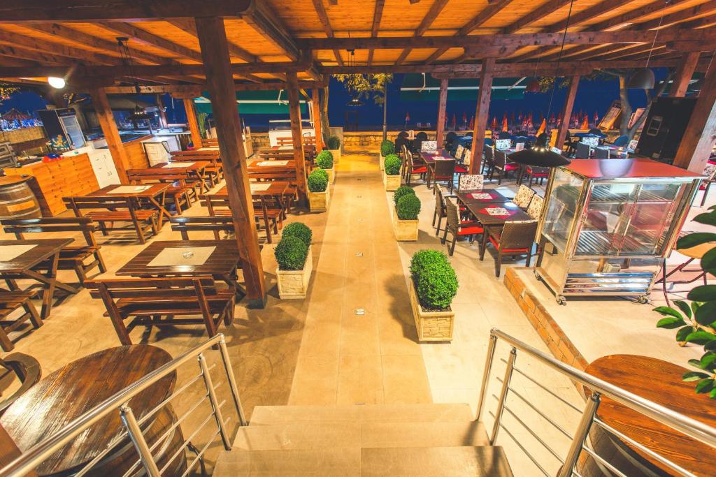 an empty restaurant with wooden tables and chairs and tables at Apartments Deus in Dobra Voda