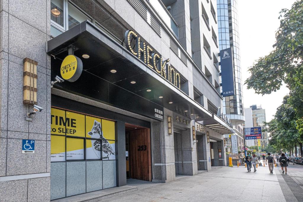 a store on a city street with people walking outside at CHECK inn Taipei Songjiang in Taipei