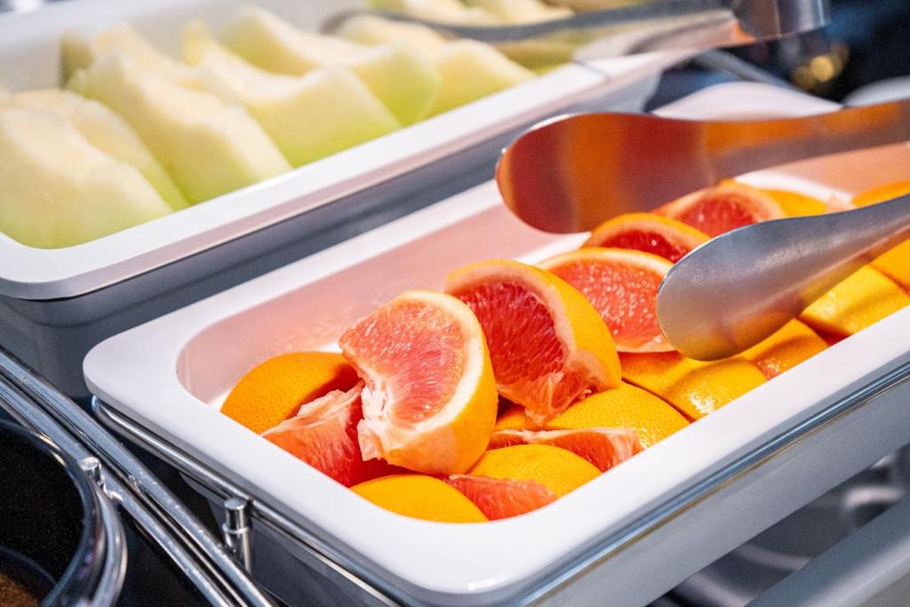 a plastic container filled with fruit and cheese at CHECK inn Taipei Songjiang in Taipei