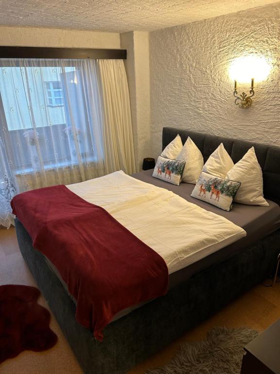 a bedroom with a large bed with two pillows at Andys Bergglück in Weidach