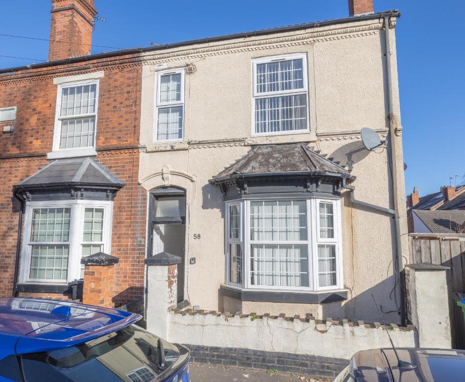 an old brick building with white windows on a street at 4 bedroom Townhouse in West Bromwich