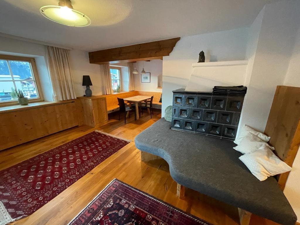 a living room with a couch and a table at Haus Ehammer in Hopfgarten im Brixental