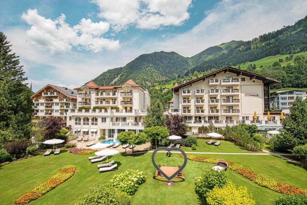 a hotel with a large garden in front of a resort at Hotel Bismarck in Bad Hofgastein