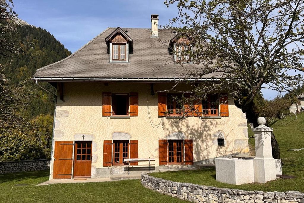 a house with a bench in front of it at Le Nid de Pajonnière en chartreuse in Saint-Pierre-de-Chartreuse