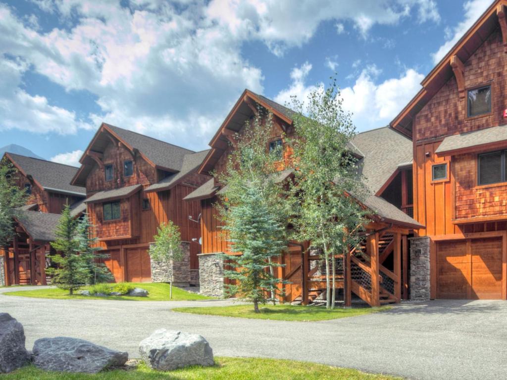 a large log home with a driveway at Black Eagle 12 in Big Sky