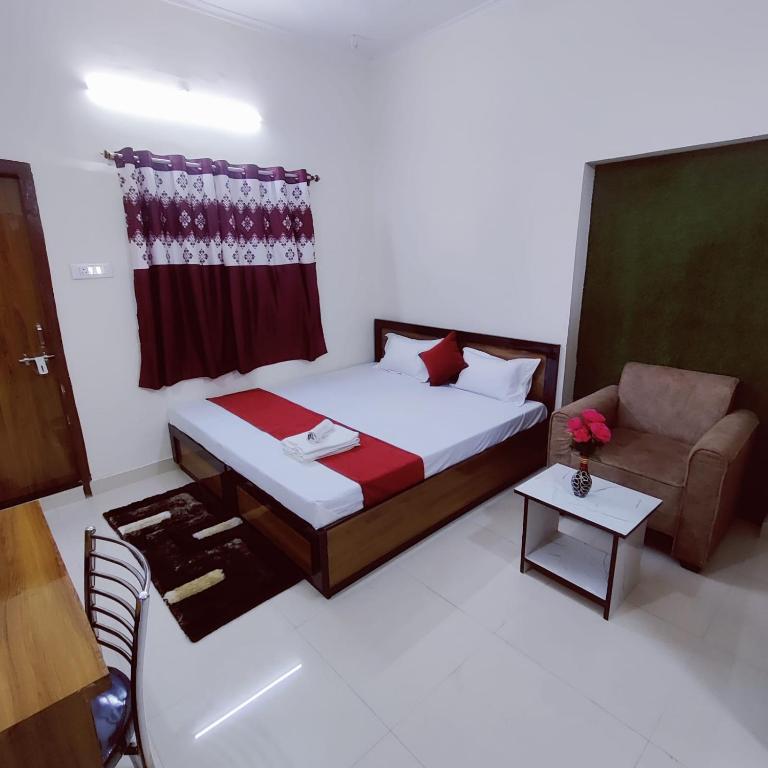 a bedroom with a bed and a chair and a couch at A K CONTINENTAL in Rānchī