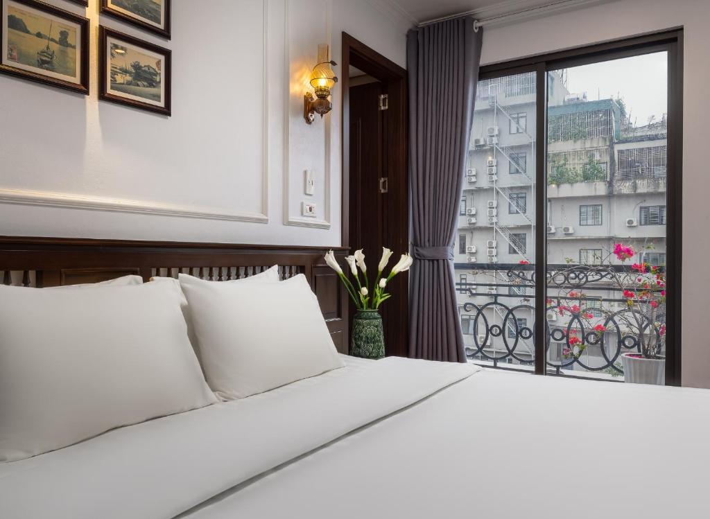 Ένα ή περισσότερα κρεβάτια σε δωμάτιο στο Paddy Hotel