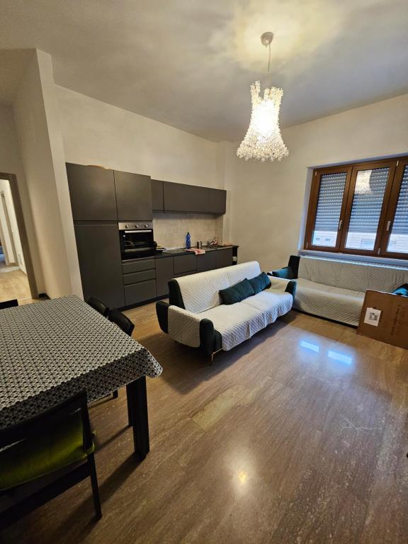a large living room with a bed and a kitchen at APPARTAMENTO IL VELINO in Rocca di Mezzo