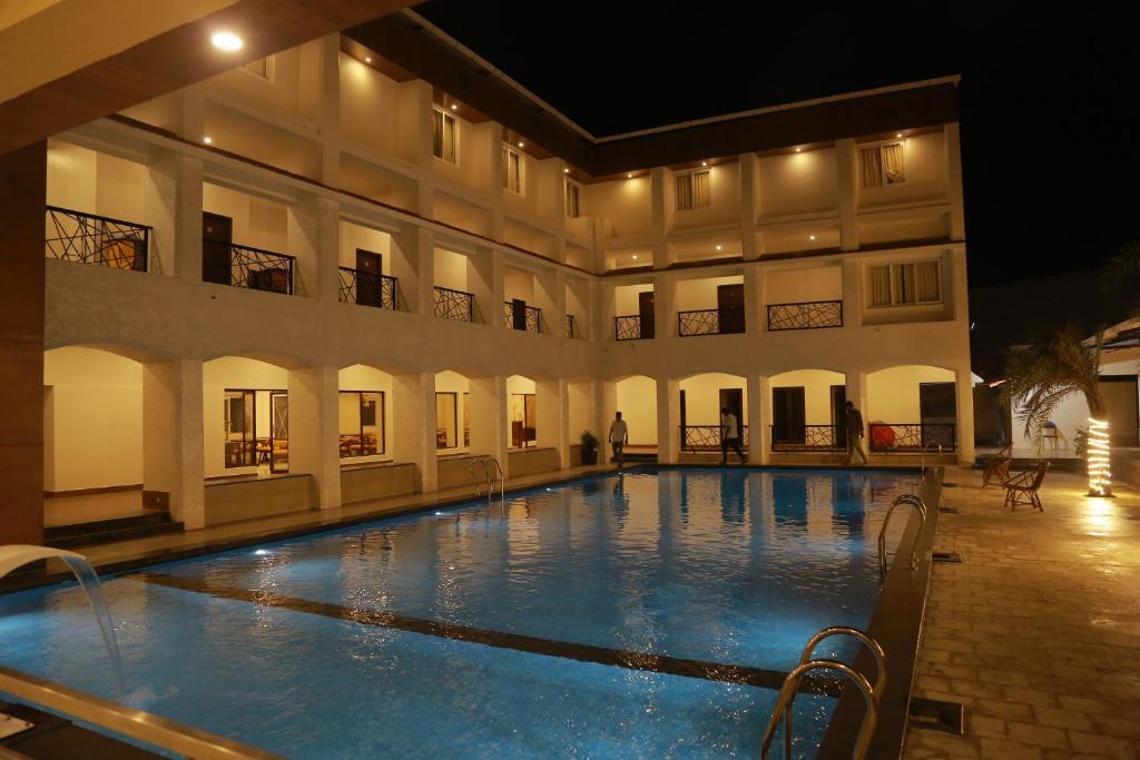 a large swimming pool in front of a building at THE RIVIERA in Theni