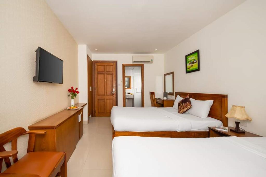 Postel nebo postele na pokoji v ubytování Twilight Beach Hotel