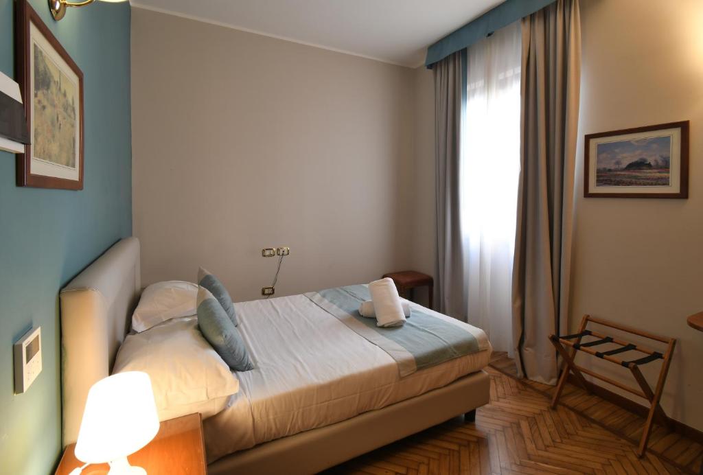 a bedroom with a bed and a window in it at Hotel Cavour in Rapallo