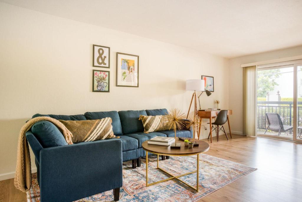 a living room with a blue couch and a table at Mountain View 1br w balcony pool nr shops SFO-1588 in Mountain View