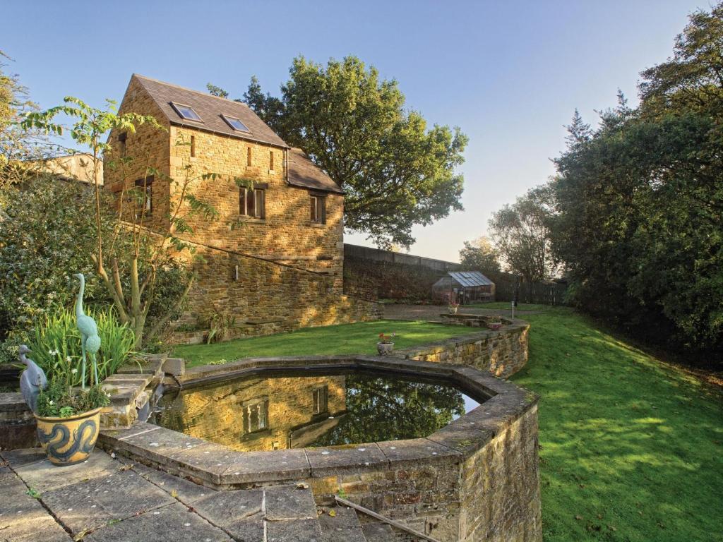 an old stone house with a pond in the yard at 2 bed in Barlow PK612 in Barlow