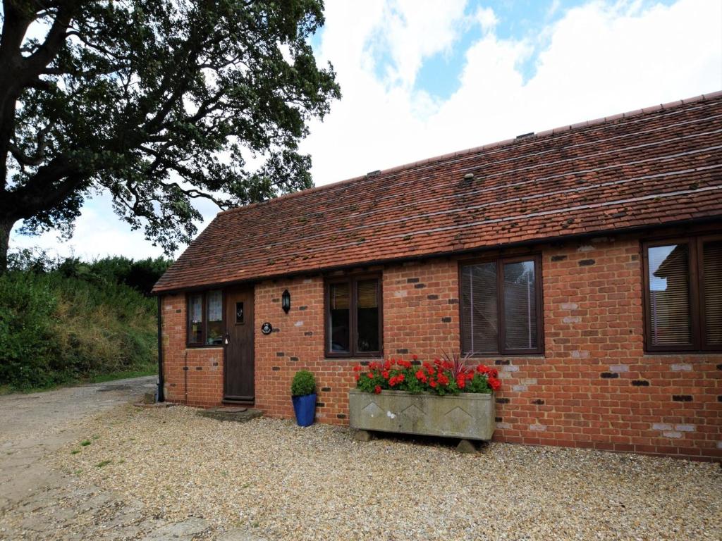 a brick building with flowers in a window at 1 bed property in Banbury CC072 in Shotteswell