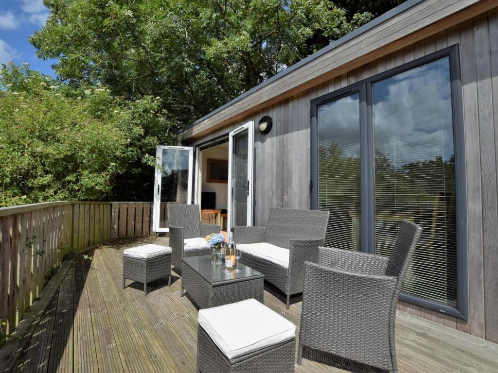a patio with chairs and a table on a deck at 2 Bed in Conwy 50284 in Llangelynin