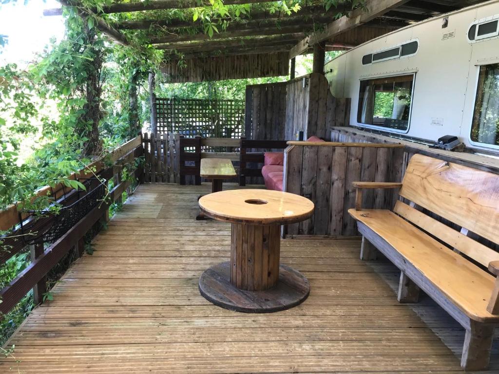 a wooden deck with a table and benches at 1 Bed in Bodiam 51574 in Bodiam