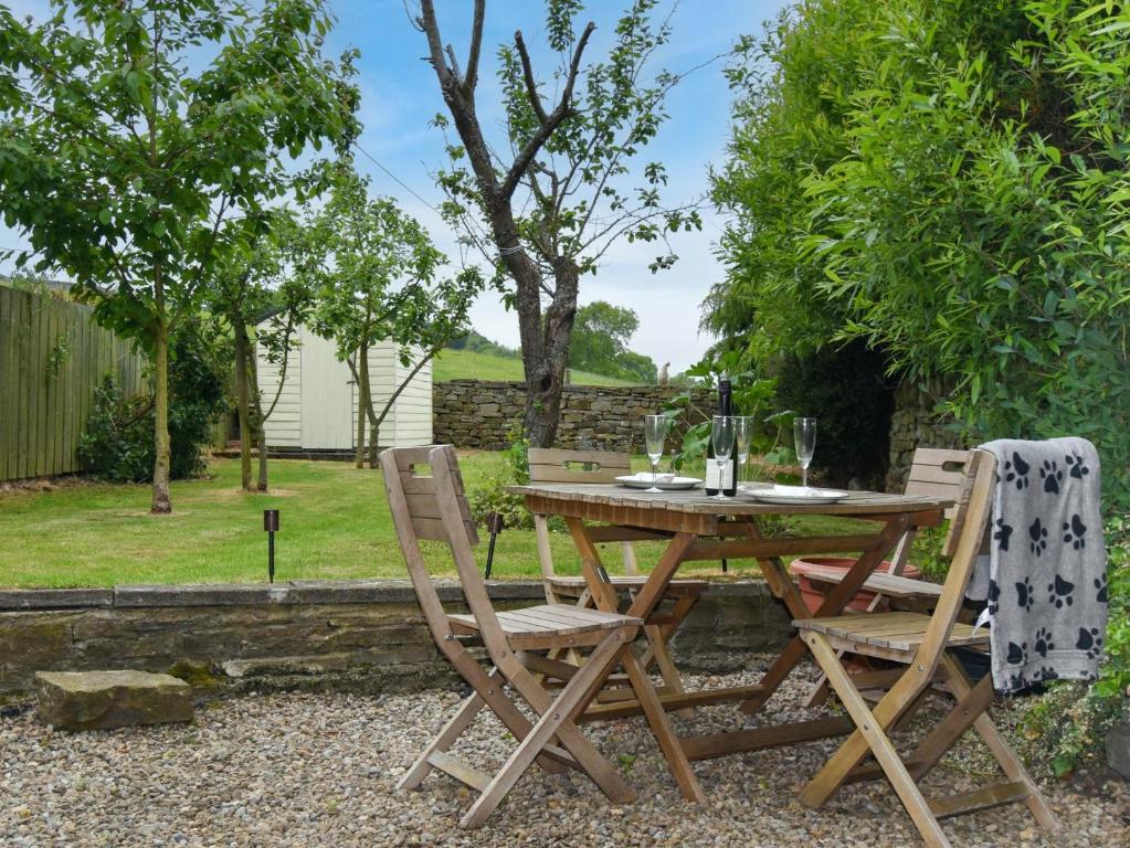 a wooden table and chairs in a garden at 2 bed in Frosterley 54143 in Frosterley
