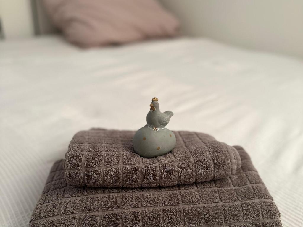 a toy chicken sitting on top of a towel on a bed at Beautiful Studio in the Heart of Salzburg in Salzburg