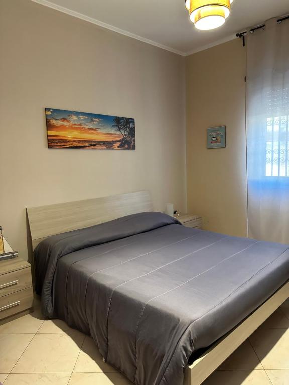 a bedroom with a large bed in a room at La Via del Mare in Torre del Greco