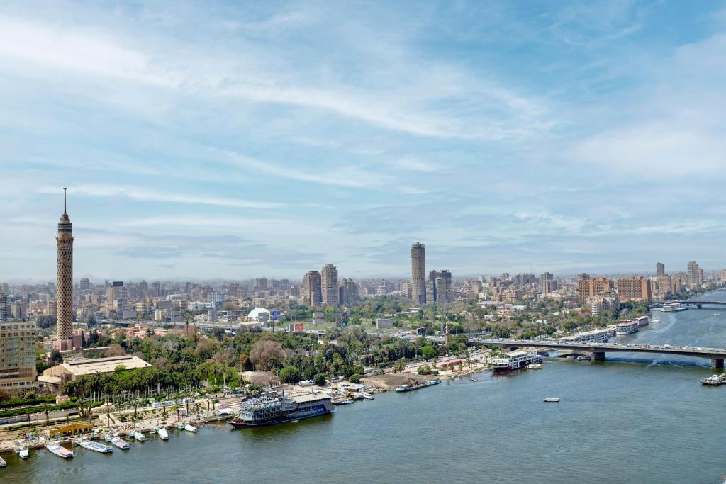 a view of a river with boats in a city at InterContinental Cairo Semiramis, an IHG Hotel in Cairo