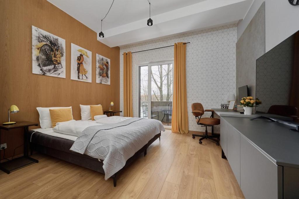 a bedroom with a bed and a sink in it at Marina Na Grobli Studio Apartments by Renters in Wrocław