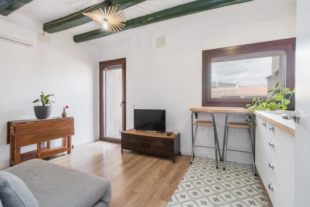 a living room with a couch and a table at Apartament Montserrat in Piera