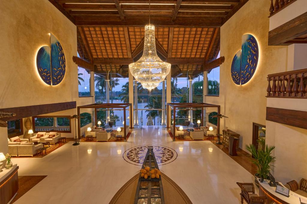 a lobby of a resort with a chandelier at The Leela Ashtamudi, A Raviz Hotel in Kollam