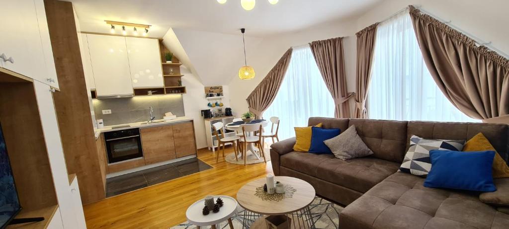 a living room with a couch and a kitchen at Cozy Corner Zlatibor in Zlatibor