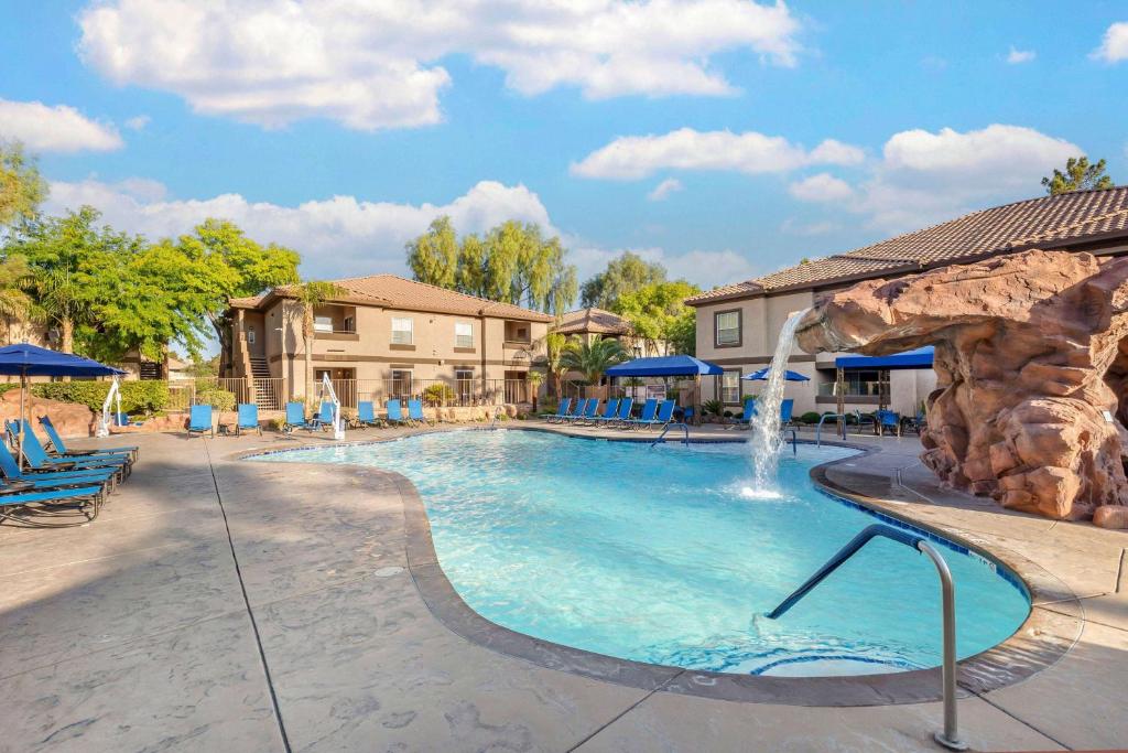 a swimming pool with a waterfall in a resort at Hilton Vacation Club Desert Retreat Las Vegas in Las Vegas