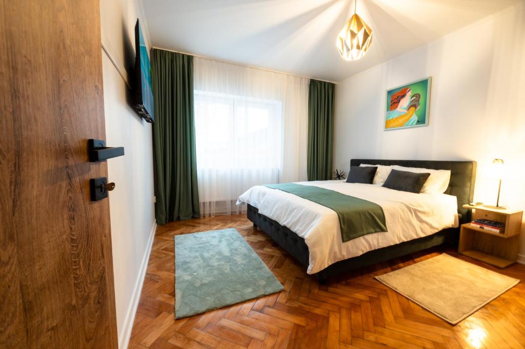 a bedroom with a bed and a television in it at Fortuna Apartments in Baia Mare