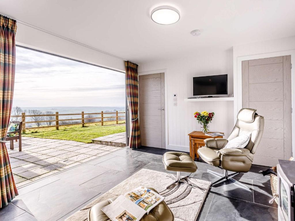 a living room with a view of the ocean at 1 Bed in Combe Martin 77349 in Loxhore