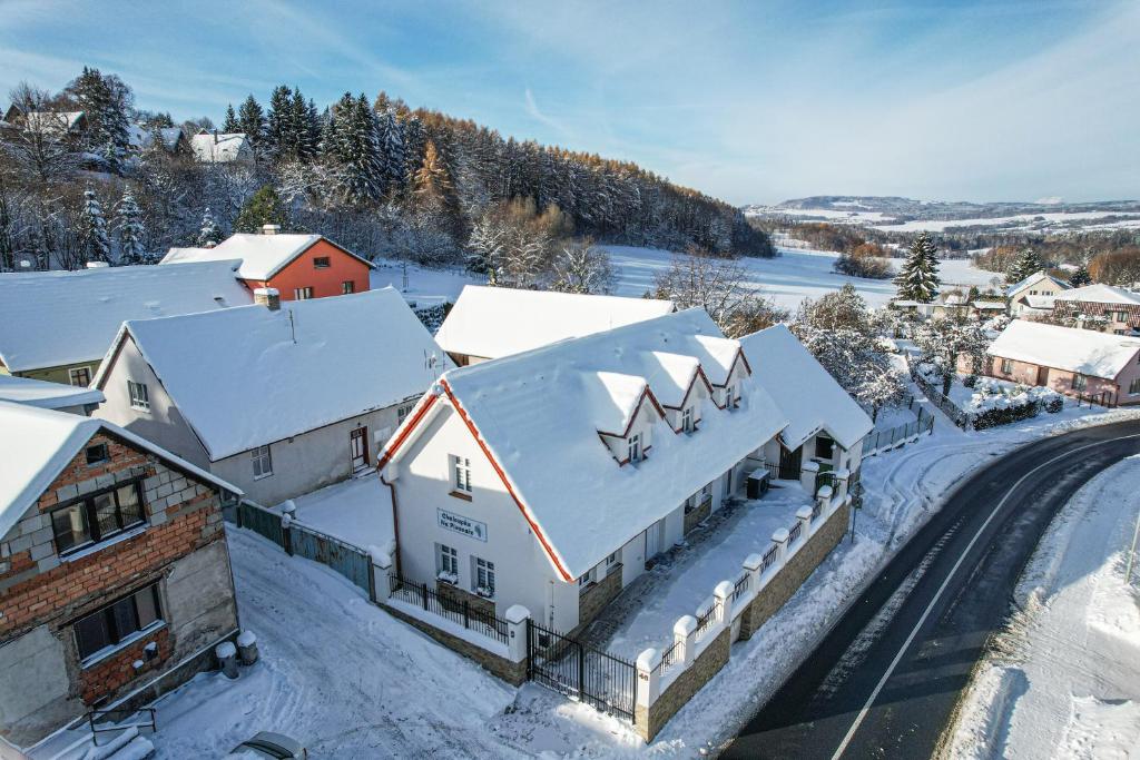 an old train station with snow covered roofs at Chaloupka Na Pivovaře Seč in Seč