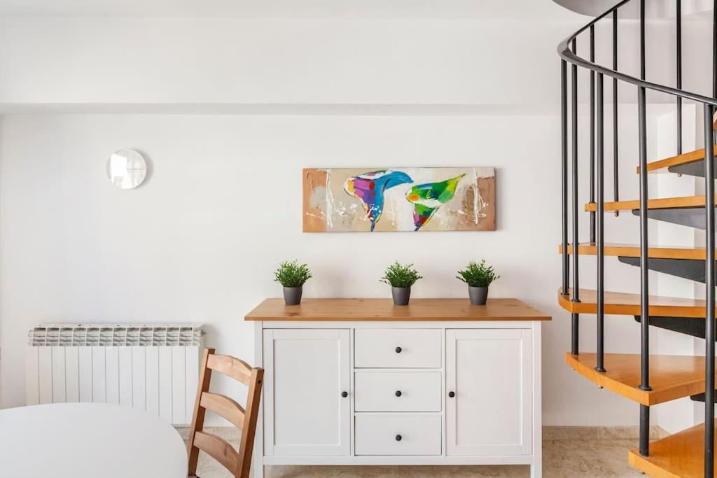 een kamer met een witte kast met planten erop bij First sea line nice duplex with terrace in Arenys de Mar