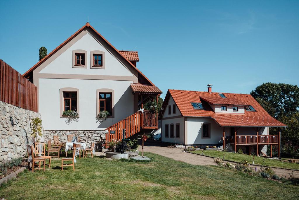 a white house with red roofs and a yard at U nás ve lhotě - apartmány / celá chalupa in Borotín