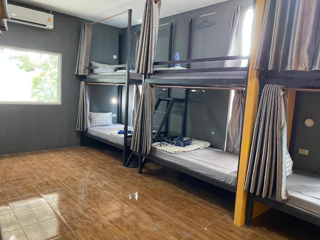 a room with three bunk beds in a dorm at The view Hostel in Phi Phi Don