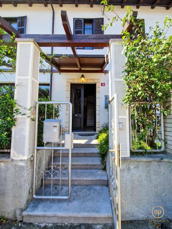 an entrance to a house with a gate and stairs at Holiday House Srečka in Izola