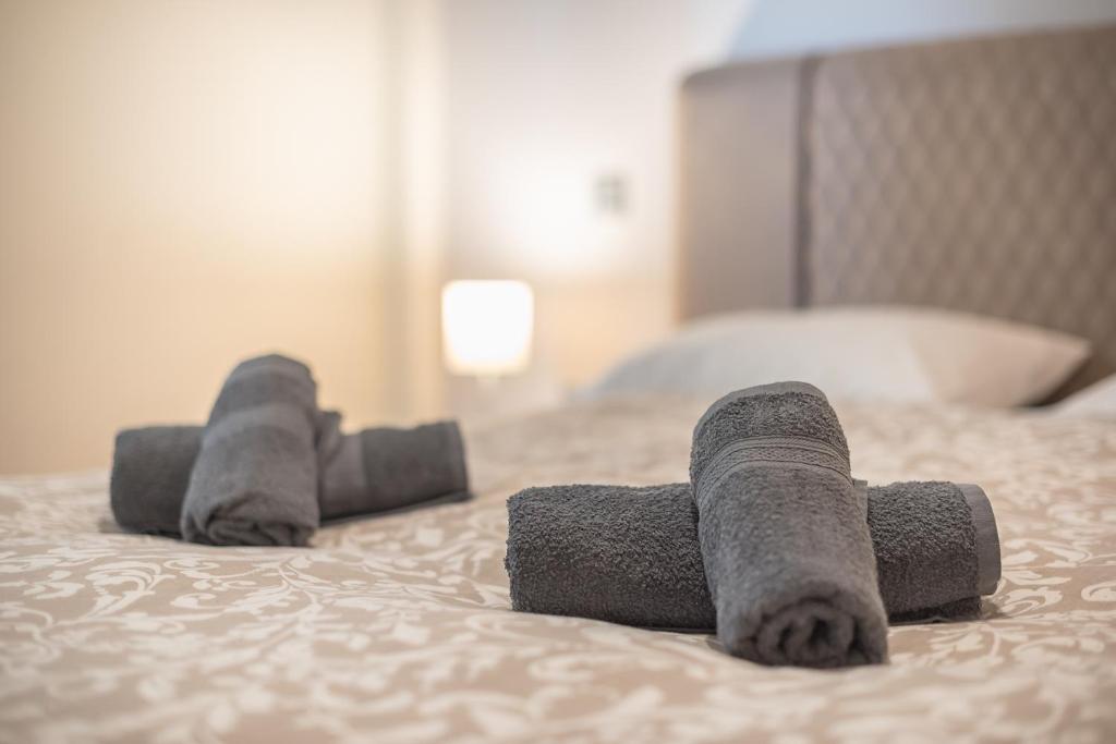A bed or beds in a room at Panathenaic Stadium By Greece Apartments