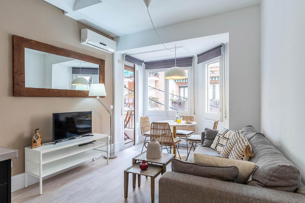 a living room with a couch and a tv at 4212 - AB Poble Sec in Barcelona