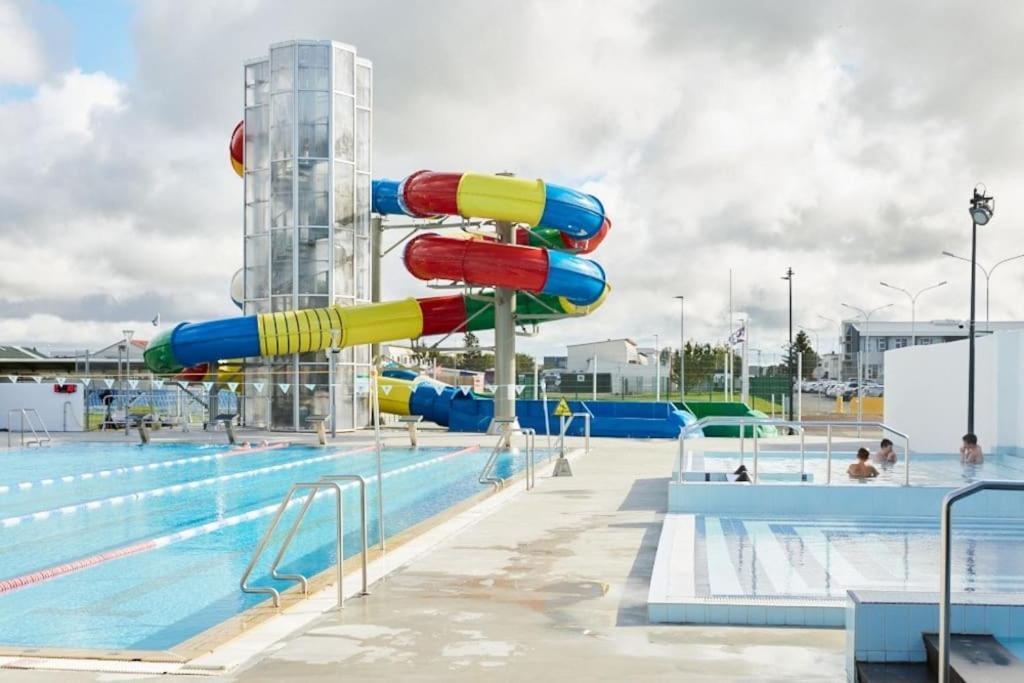a water slide in a pool at a water park at Excellent location in Keflavík at Faxabraut 49. in Keflavík