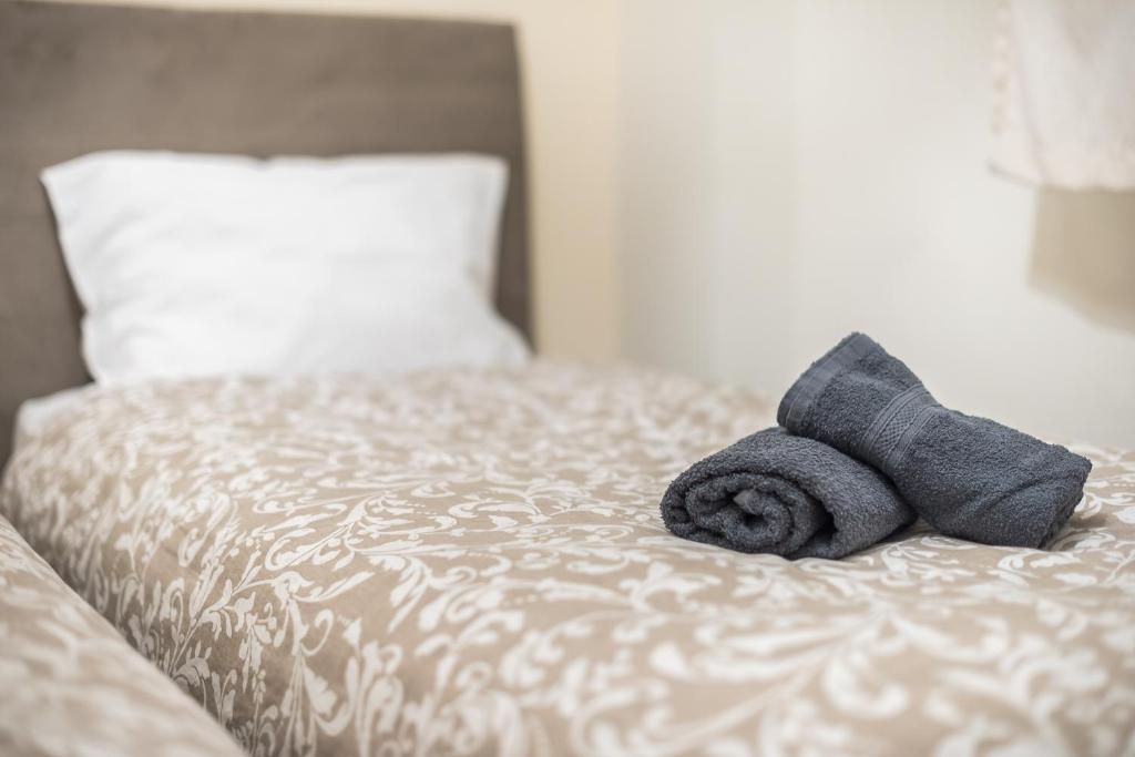 A bed or beds in a room at Panathenaic Stadium By Greece Apartments