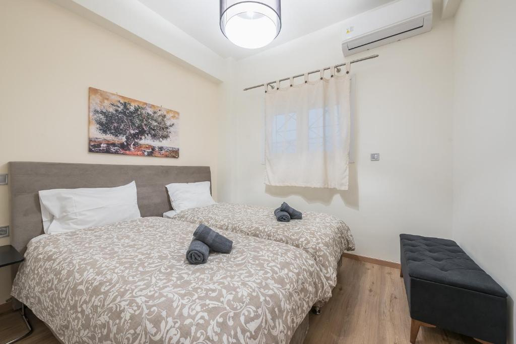 A bed or beds in a room at Panathenaic Stadium By Greece Apartments