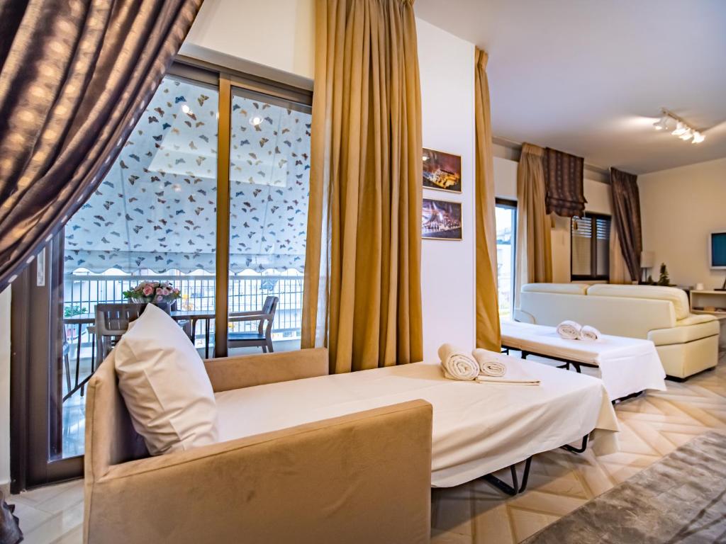 a hotel room with a bed and a living room at Yianni's Home-Comfort Apartment in Volos in Volos