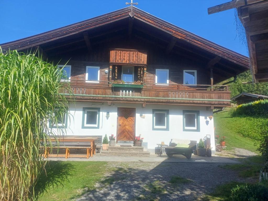 a large white house with a wooden roof at Ferienhaus Lemberger in Jochberg