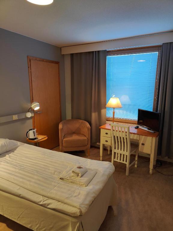 Postel nebo postele na pokoji v ubytování Hotel Karhu