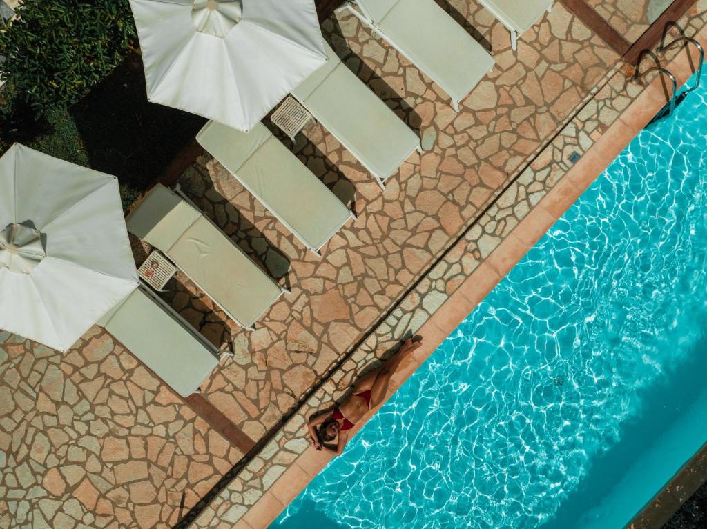 an overhead view of a swimming pool with umbrellas at Dracos Hotel in Parga
