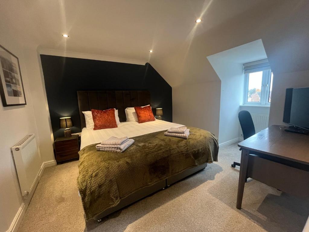 1 dormitorio con 1 cama grande, escritorio y TV en Stamford House - Short Stays and Contractors, en Lincolnshire