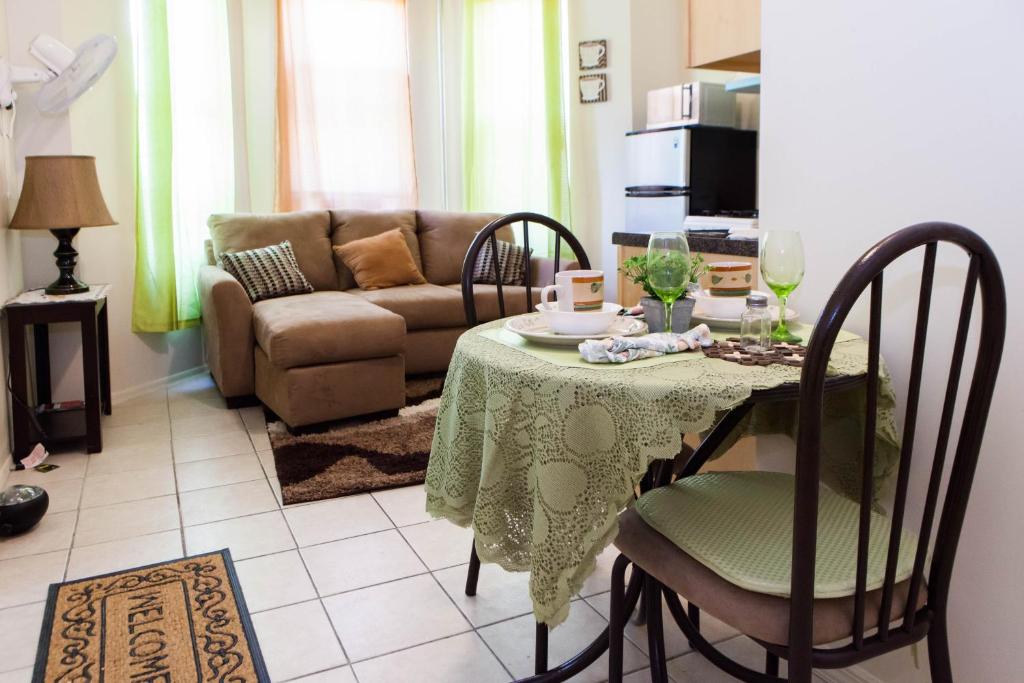 a living room with a table and a couch at STUDIO and ONE BEDROOM APARTMENTS in Bronx